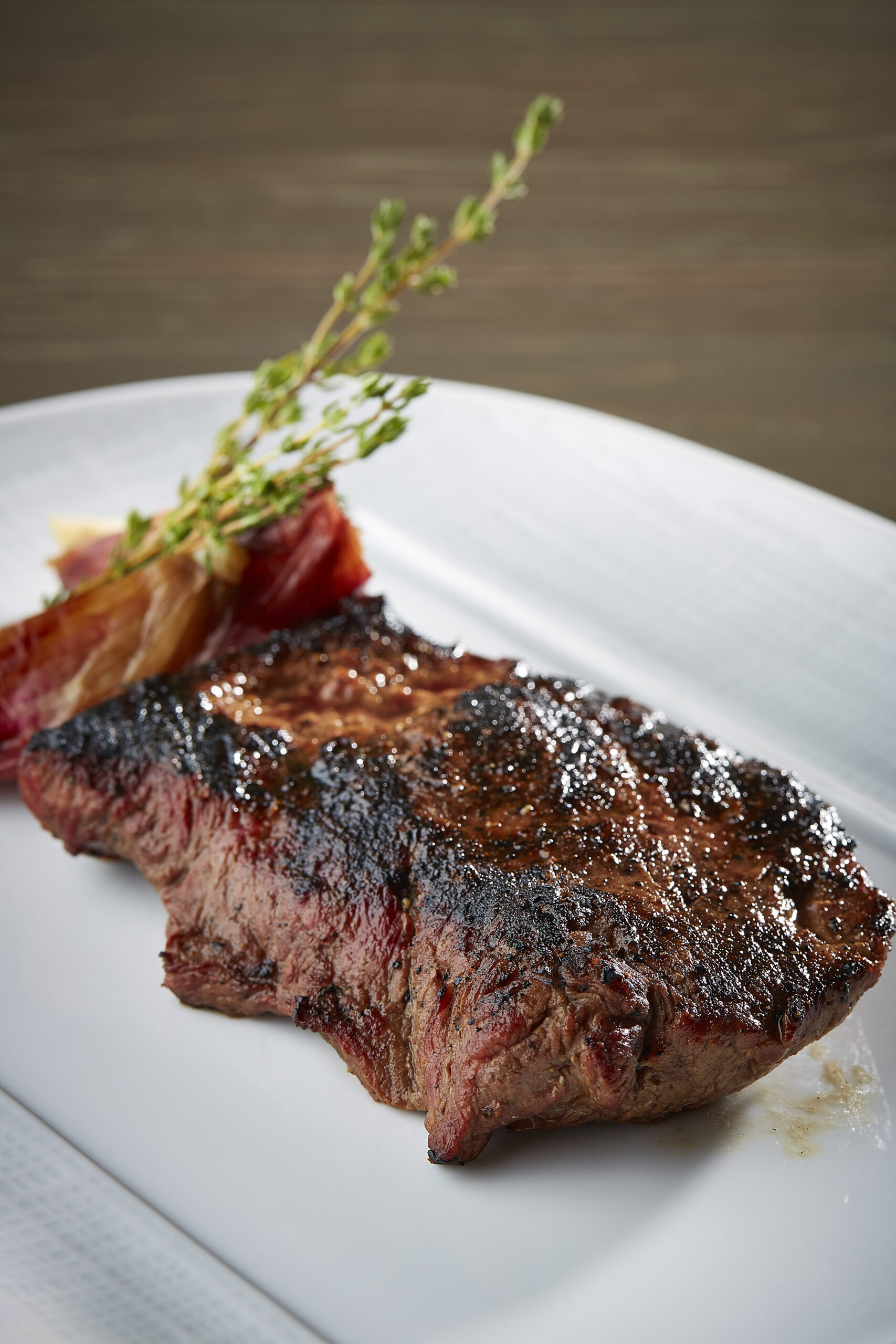 Flat iron steak on a white plate from Knife