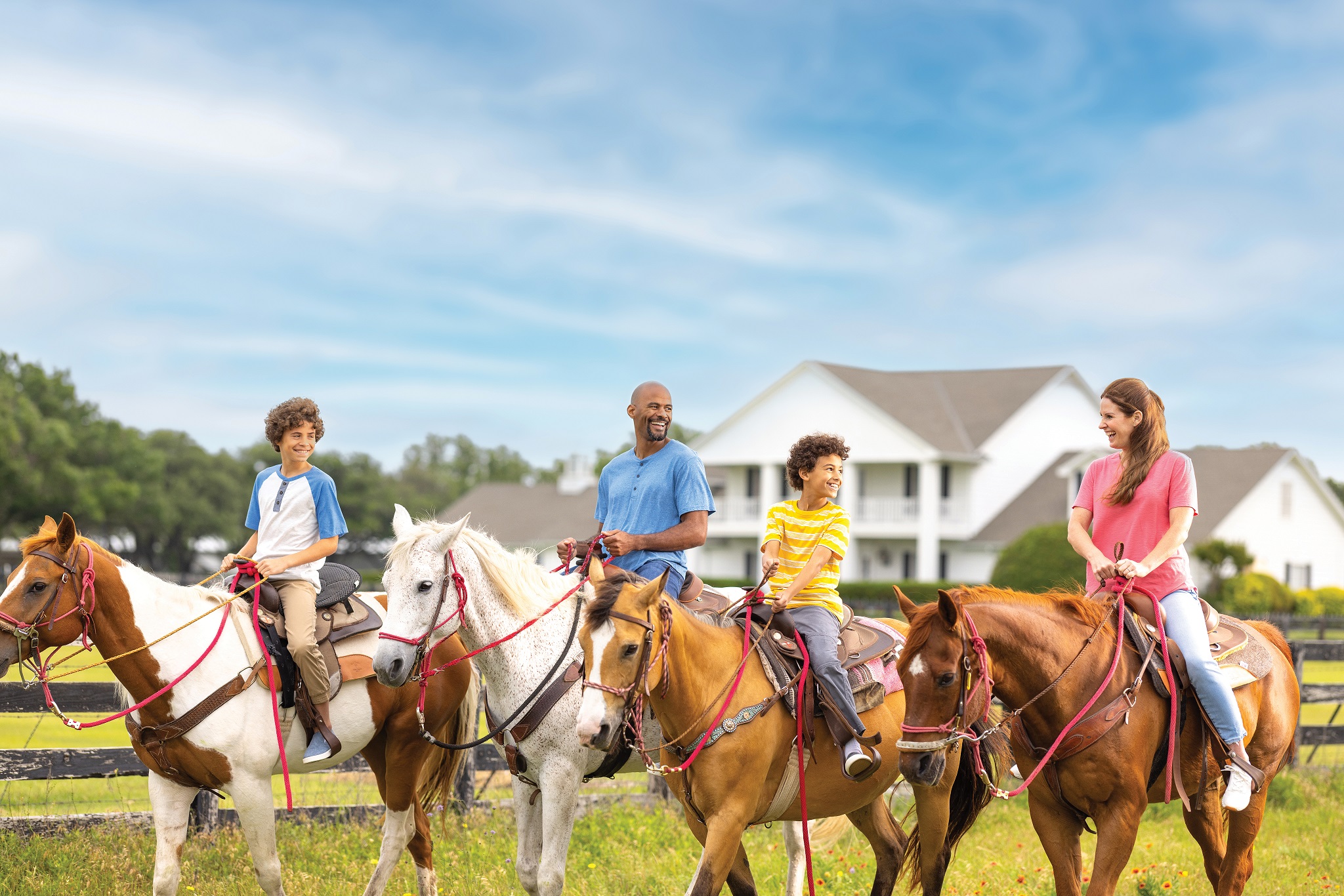 Family horseback trail riding at Southfork Ranch