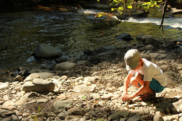 Kids with rocks at creek Adobe Stock Photo
