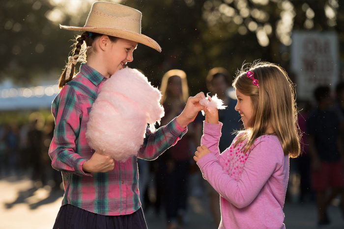 Girls sharing cotton candy at State Fair