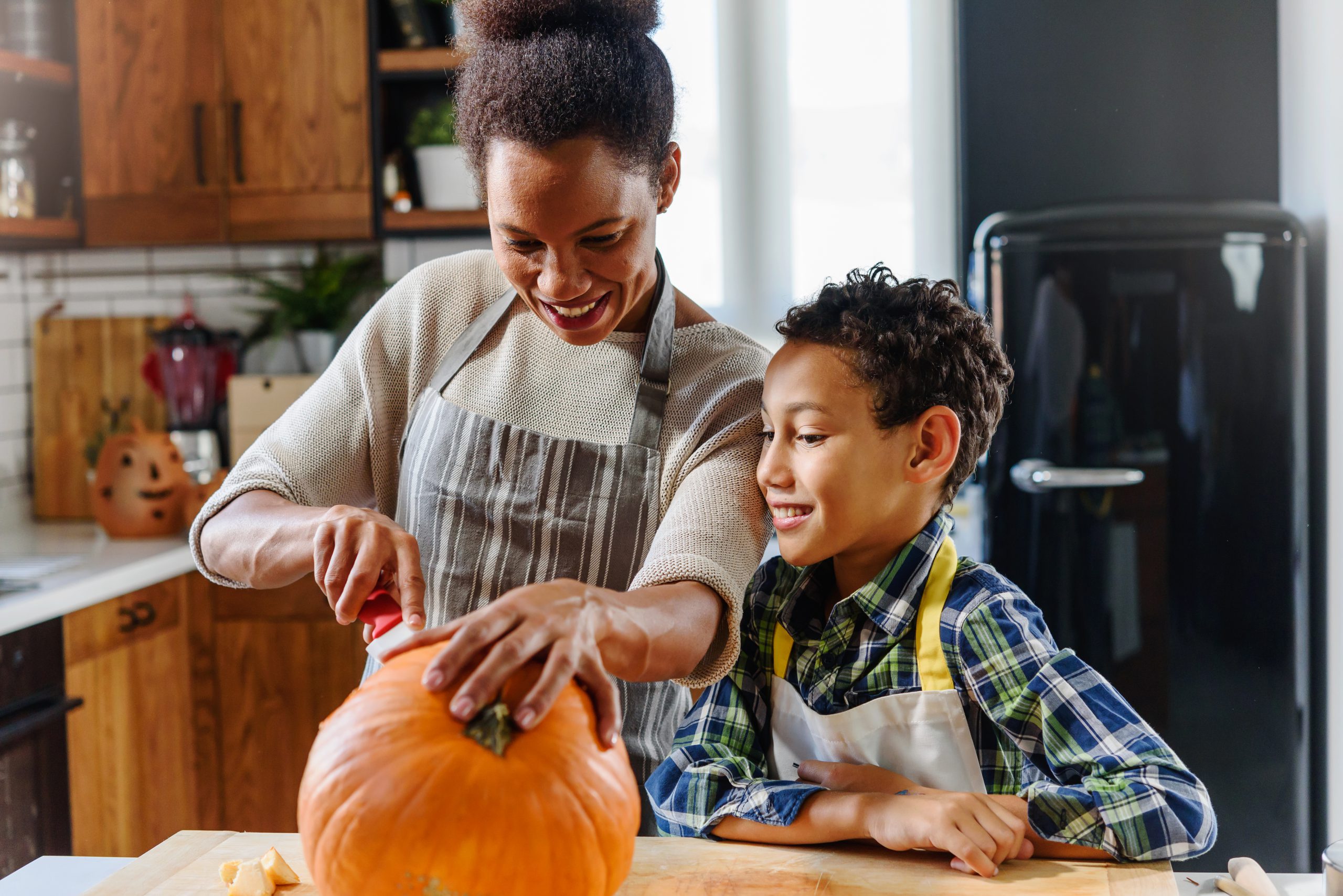 Mom and son pumpkin carving