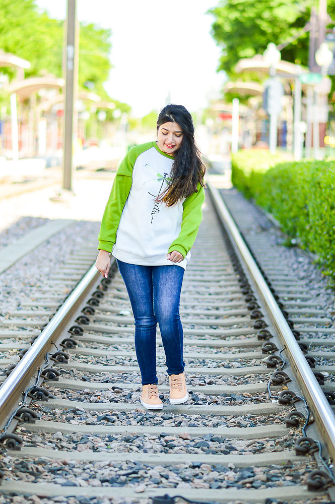 Dallas Paki Blogger, Layla Komal, in downtown Plano Arts District posing on the DART tracks