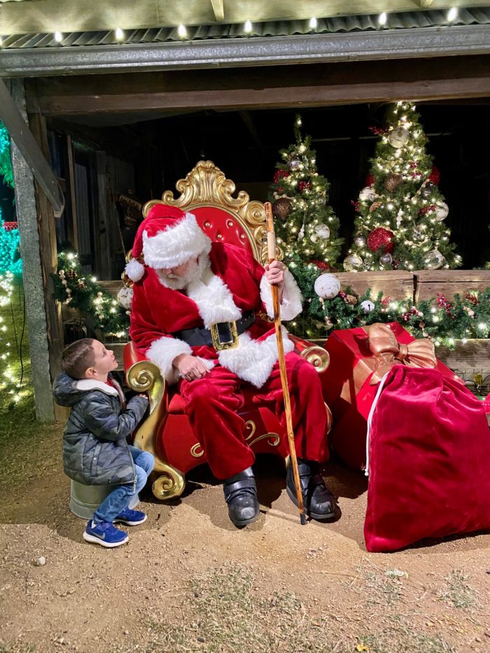 Heritage Farmstead Lights on the Farm Boy talking with Santa