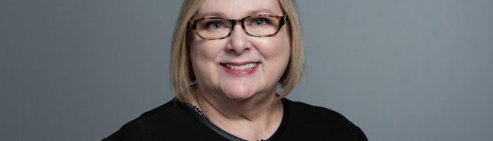 Karen Fogle headshot with gray background