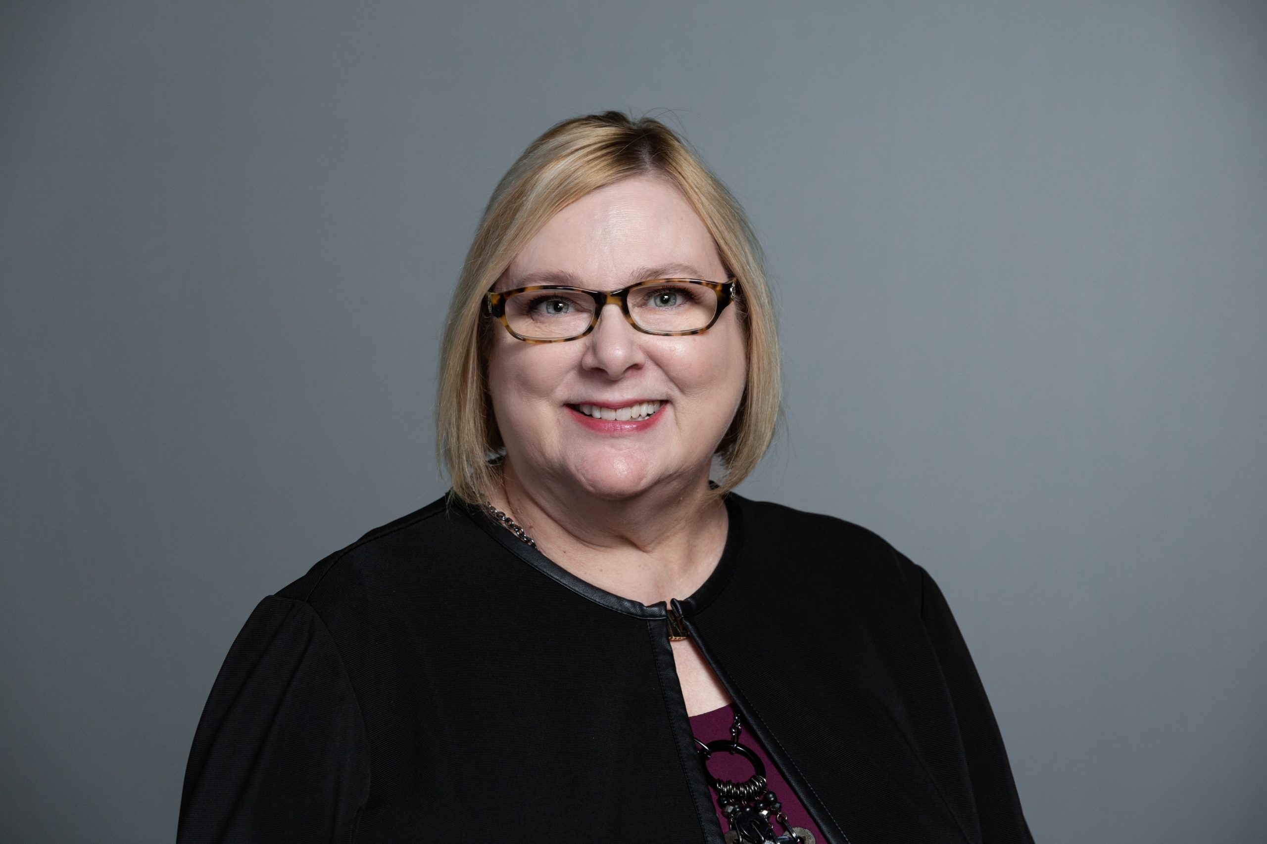 Karen Fogle headshot with gray background