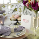 Mother's Day in Plano Texas - table setting with flowers, champagne, and MOM table sign