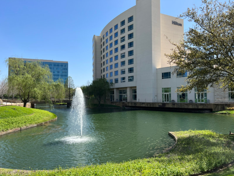 Hilton Granite Park Hotel exterior of building and water feature