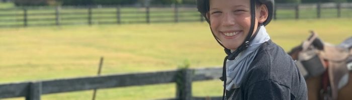 Boy horseback riding at Southfork Ranch near Plano, TX