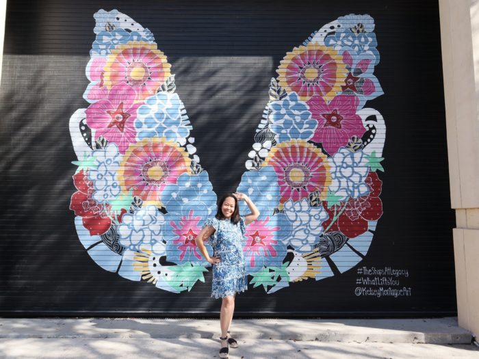 Rory posing in front of the butterfly mural at The Shops at Legacy in Plano.