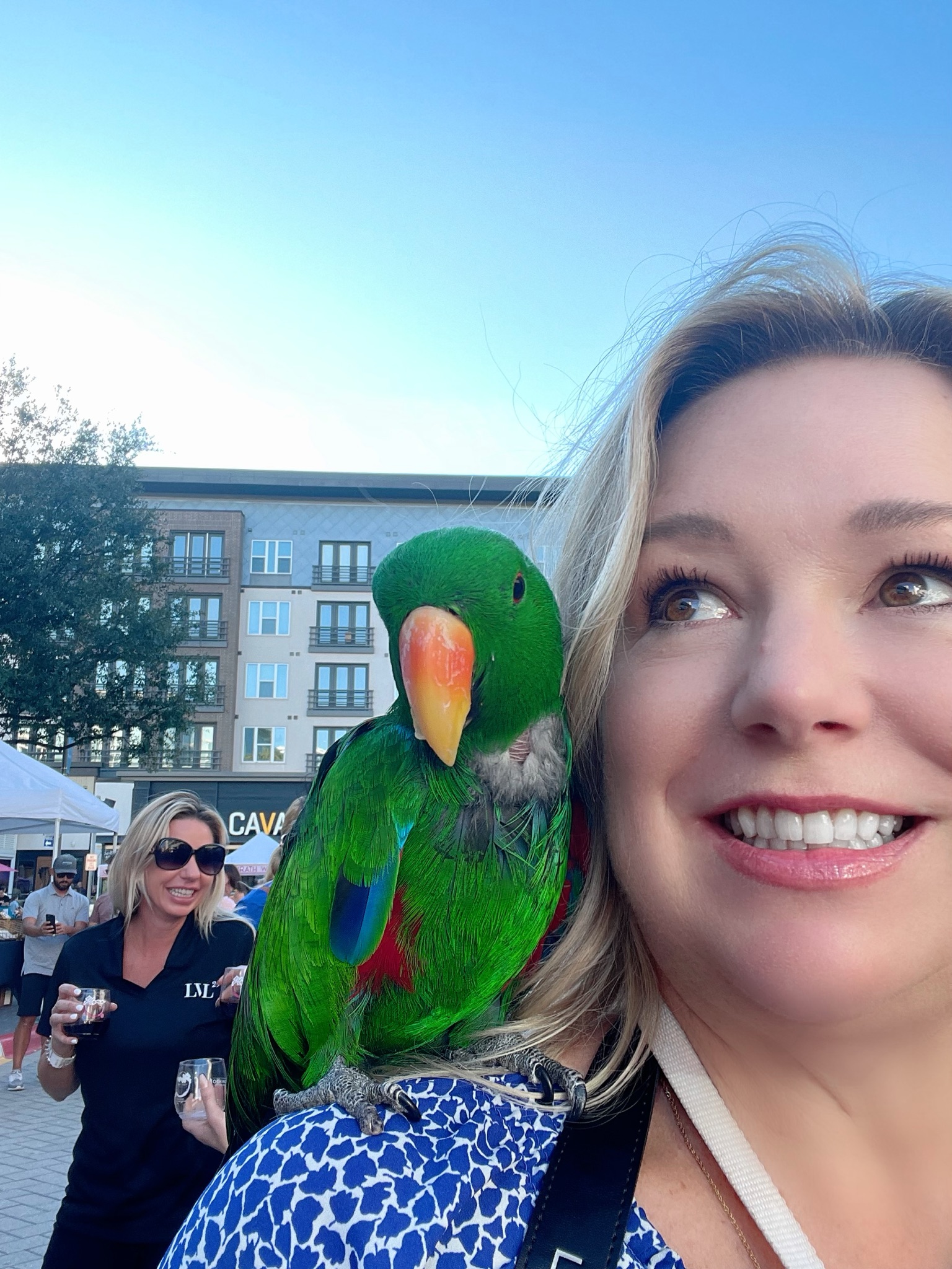 Stephanie with a parrot on her shoulder at the Plano Food & Wine Festival