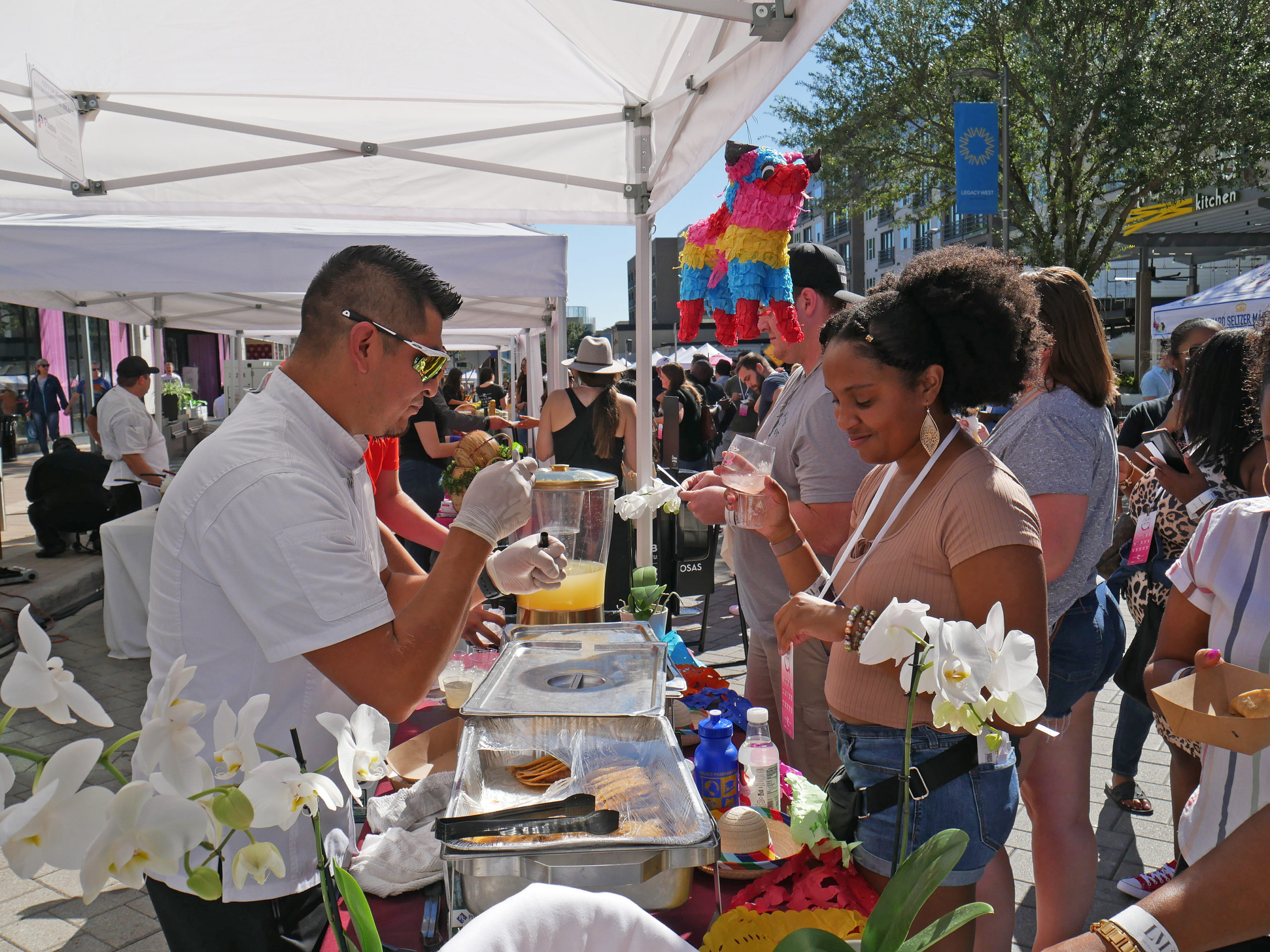 Plano Food & Wine Festival vendor giving attendee a sampling