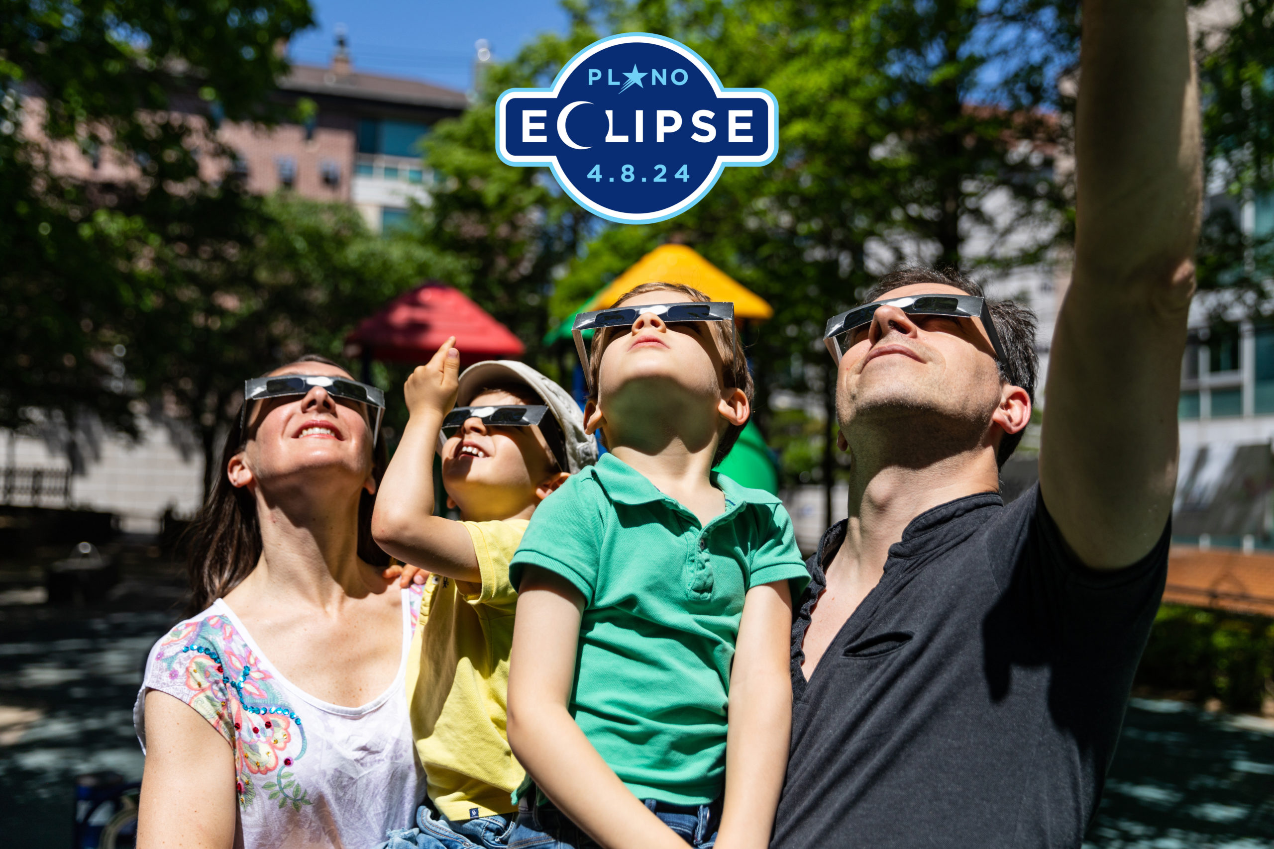 Family looking up with eclipse glasses in Plano, TX