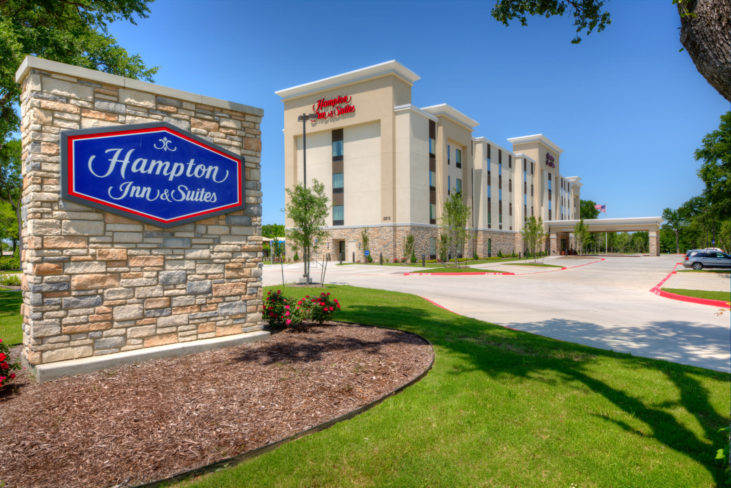Hampton Inn & Suites Plano East exterior with street signage