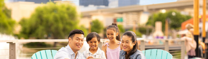 Family sitting taking a selfie at The Boardwalk at Granite Park