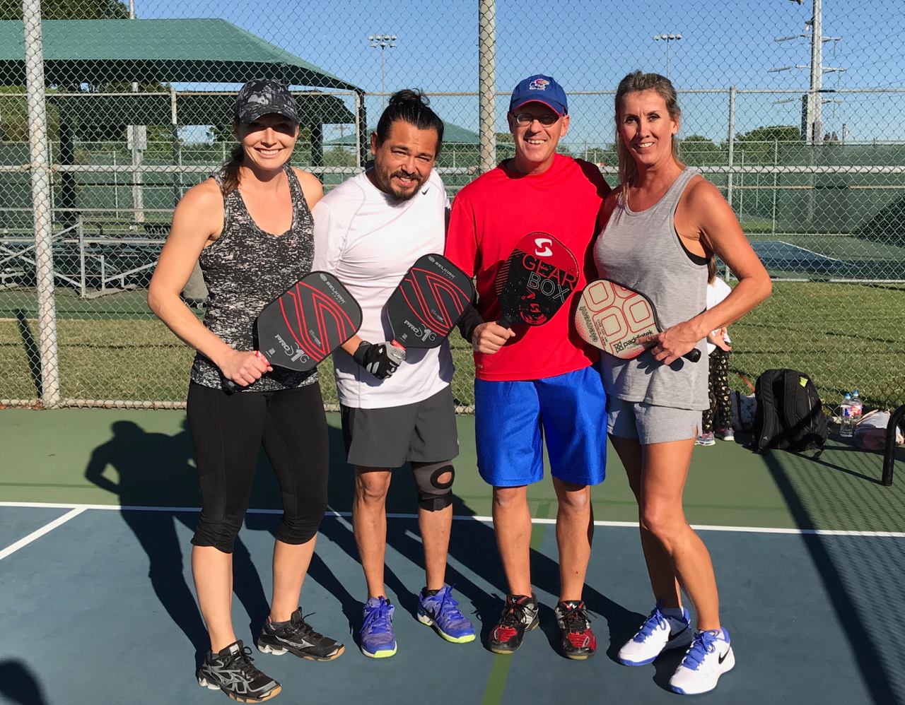 Pickleball duos posing before a game at High Point