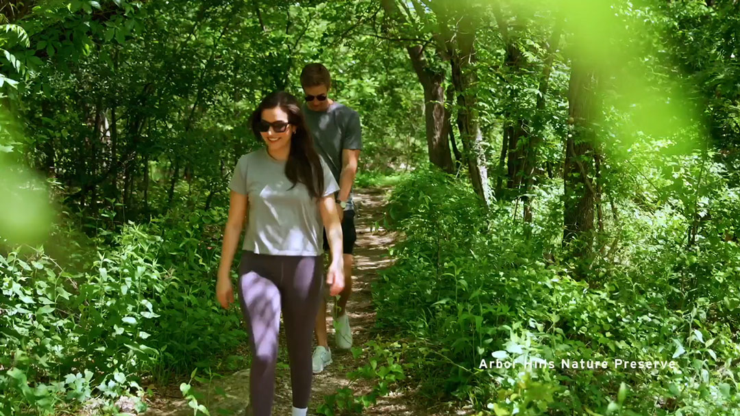 Two couples walking through the Arbor Hills Nature Preserve trail.