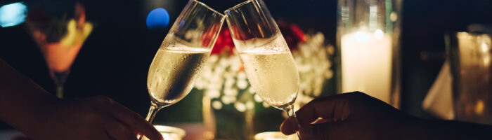 Toasting Champagne at candle lit dinner
