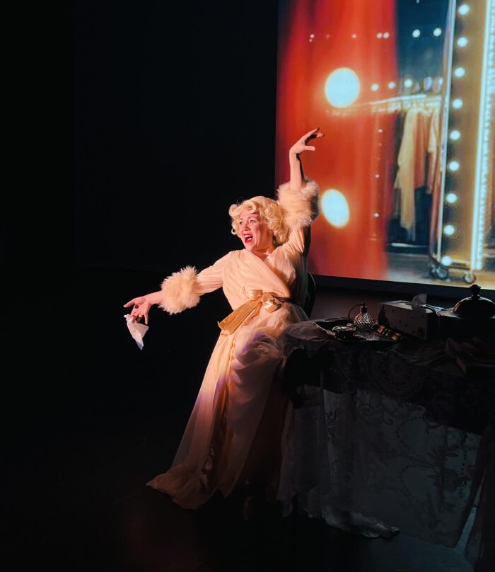 Repertory Company Theatre promotional photo with an actress on the stage