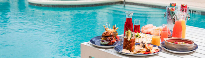 Dallas/Plano Marriott at Legacy Town Center pool with colorful food and drink options on a table by the pool