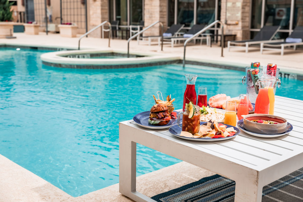 Dallas/Plano Marriott at Legacy Town Center pool with colorful food and drink options on a table by the pool