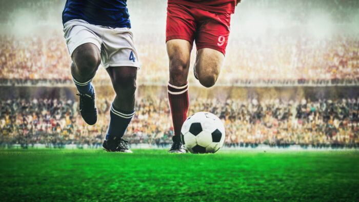 Low Section Of Players Playing Soccer On Field
