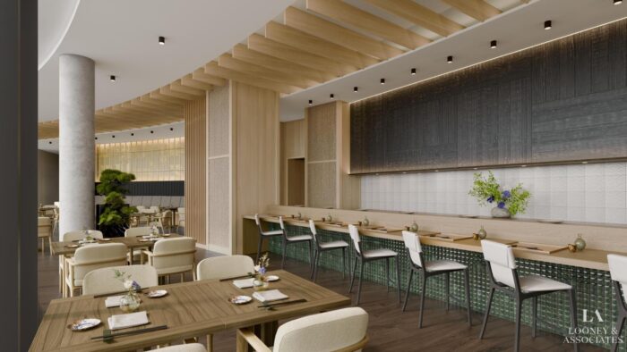 Modern restaurant interior with wooden accents, light-colored chairs, a sleek bar with green tile, and a minimalist aesthetic. Tables are set for dining and a tall plant adds greenery. Soft lighting creates a welcoming atmosphere.