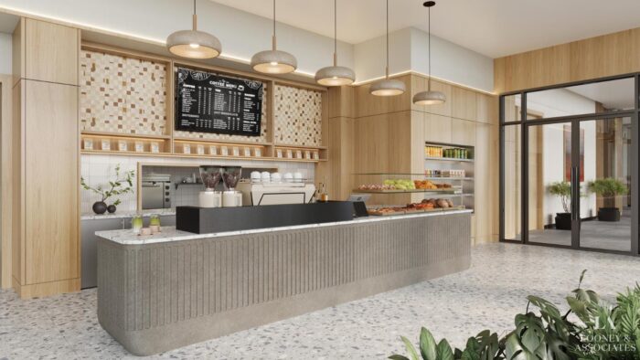 A modern coffee shop interior with a long counter, espresso machine, pastries on display, menu board above, wooden cabinetry, pendant lights, glass doors, and plants by the entrance.