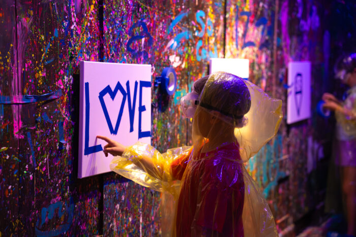 Kid touching Love Painting