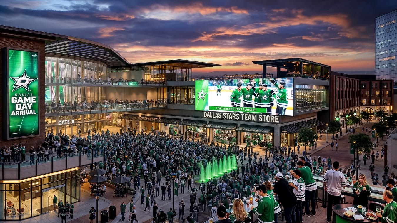 A large crowd of Dallas Stars hockey fans, many wearing green jerseys, gathers outside an arena at sunset. A big screen shows a game, and a team store with bright signage is visible. The atmosphere is festive and lively.