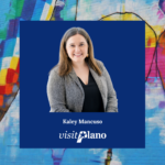 A smiling woman in a gray blazer and black shirt is centered on a blue square with the text Kaley Mancuso, Visit Plano, and Team. The background features a colorful mural of hot air balloons on a brick wall.